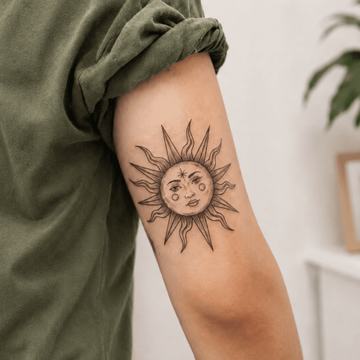 Sonnen-Tattoo mit Gesicht am Arm